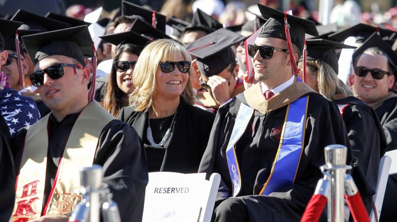 Judy O'Connor, center, sits with her son, MBA graduate Marty O'Connor, during commencement at Chapman University in Orange, Calif.